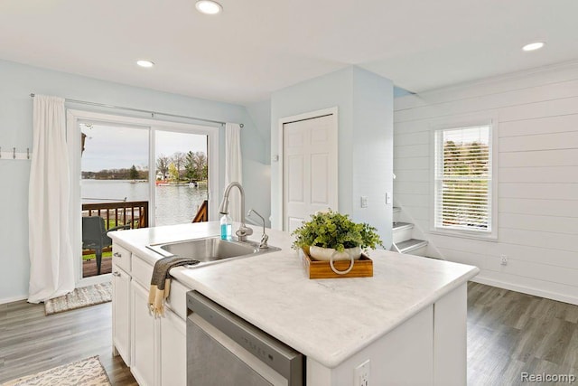 1319 Rochester Rd, Leonard, MI 48367 - kitchen featuring stainless steel dishwasher, a sink, wood finished floors, white cabinetry, and baseboards
