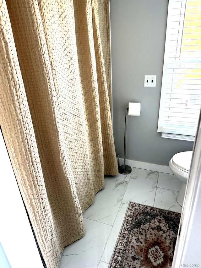 1319 Rochester Rd, Leonard, MI 48367 - bathroom featuring marble finish flooring, toilet, and baseboards