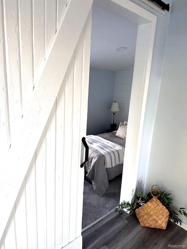 1319 Rochester Rd, Leonard, MI 48367 - bedroom with a barn door and wood finished floors