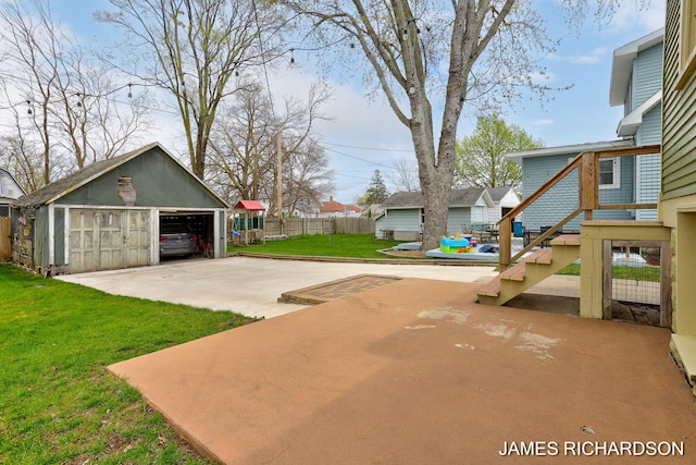 exterior space featuring fence, an outdoor structure, and a garage