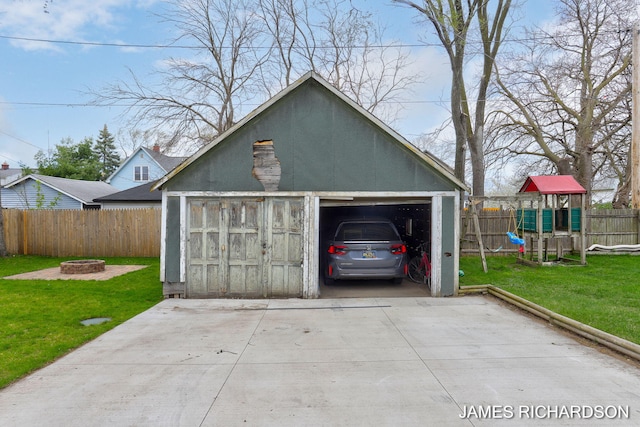 detached garage featuring fence