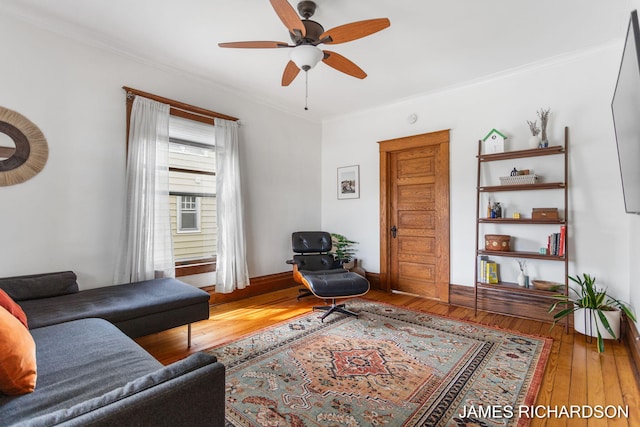 living area featuring ceiling fan, ornamental molding, and hardwood / wood-style floors