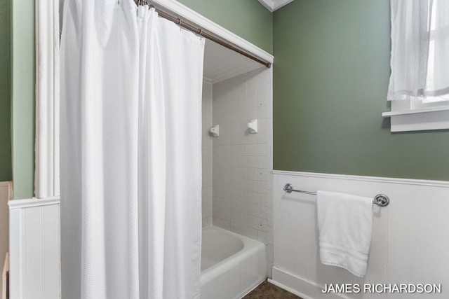 full bath with shower / bath combo with shower curtain and wainscoting