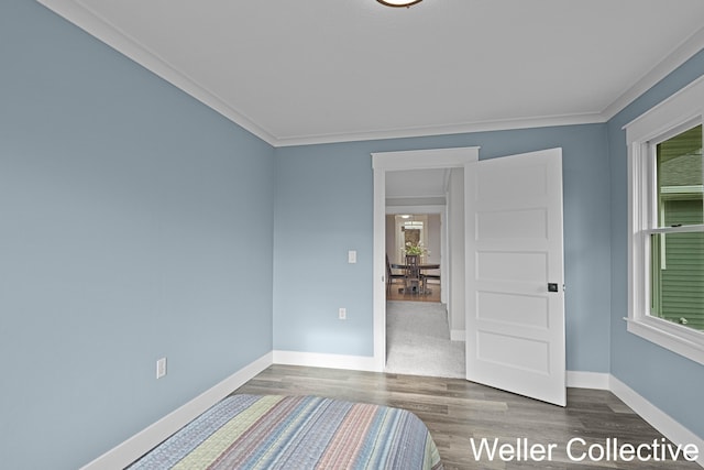 unfurnished bedroom with baseboards and wood finished floors