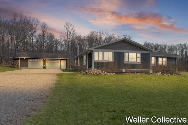 view of front of house featuring board and batten siding, an attached garage, driveway, and a front yard