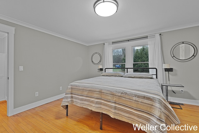 bedroom featuring crown molding, baseboards, and light wood-style floors