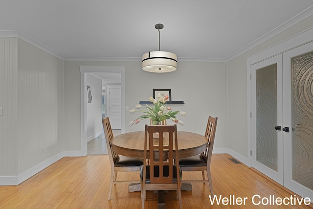 9090 E 32nd Rd, Cadillac, MI 49601 - dining space with french doors, light wood finished floors, and ornamental molding
