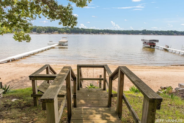 view of dock with boat lift and a water view