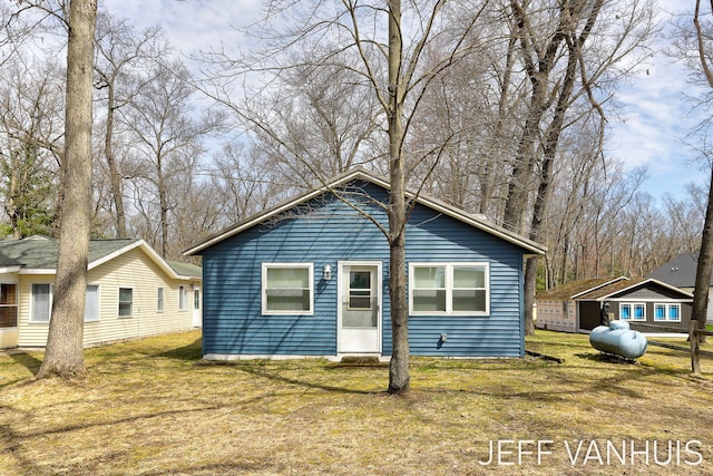 rear view of house with a lawn
