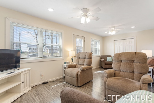 living area featuring recessed lighting, ceiling fan, baseboards, and light wood finished floors
