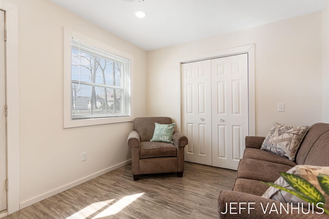 living area with recessed lighting, baseboards, and wood finished floors