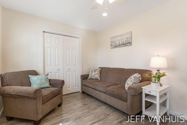 living area featuring a ceiling fan and wood finished floors
