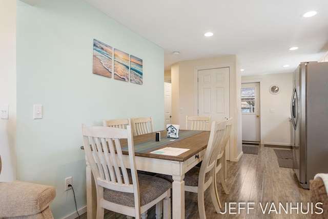 dining room featuring baseboards, recessed lighting, and wood finished floors