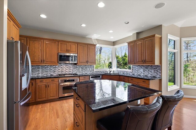 kitchen with plenty of natural light, a sink, light wood-style flooring, and stainless steel appliances