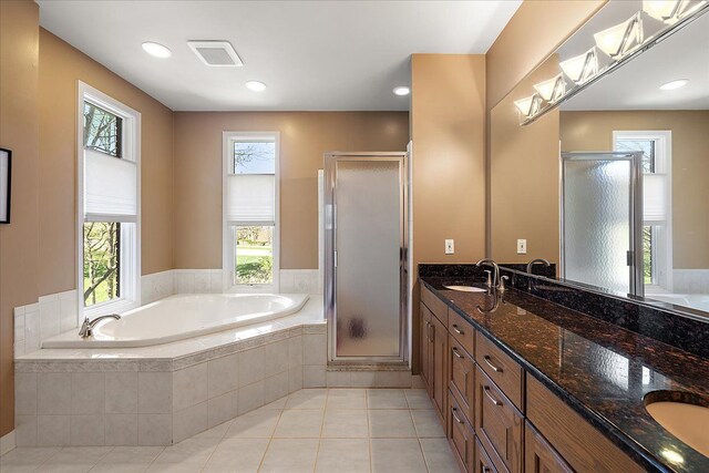 full bathroom featuring a sink, double vanity, visible vents, a garden tub, and a stall shower