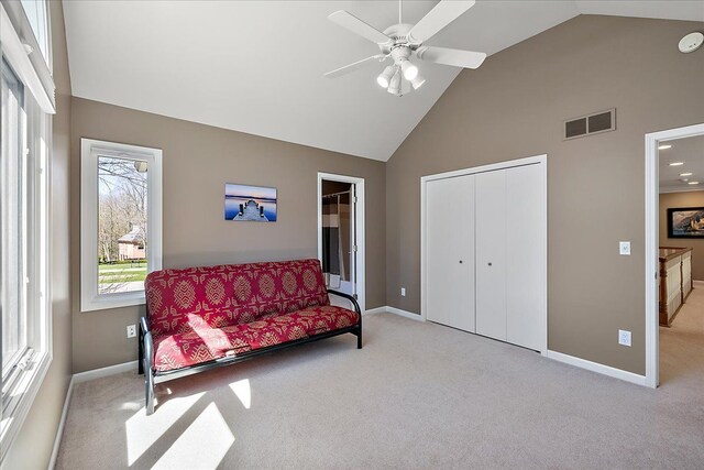 sitting room with high vaulted ceiling, baseboards, carpet, and visible vents