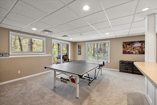 playroom featuring baseboards, light colored carpet, a paneled ceiling, and visible vents