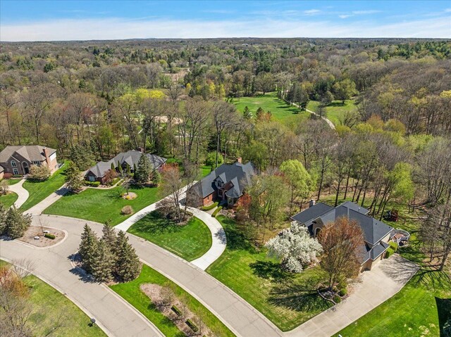 drone / aerial view with a residential view and a view of trees