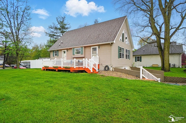 3325 Saint Anthony Rd, Temperance, MI 48182 - rear view of property featuring roof with shingles, a wooden deck, and a lawn