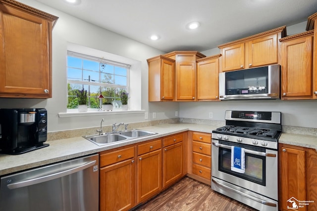 3325 Saint Anthony Rd, Temperance, MI 48182 - kitchen with appliances with stainless steel finishes, a sink, light countertops, wood finished floors, and recessed lighting