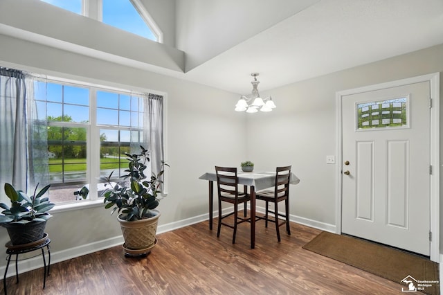 3325 Saint Anthony Rd, Temperance, MI 48182 - dining area featuring a chandelier, wood finished floors, and baseboards