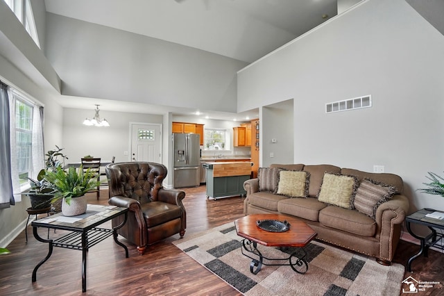 3325 Saint Anthony Rd, Temperance, MI 48182 - living room with a high ceiling, a chandelier, and dark wood-style flooring