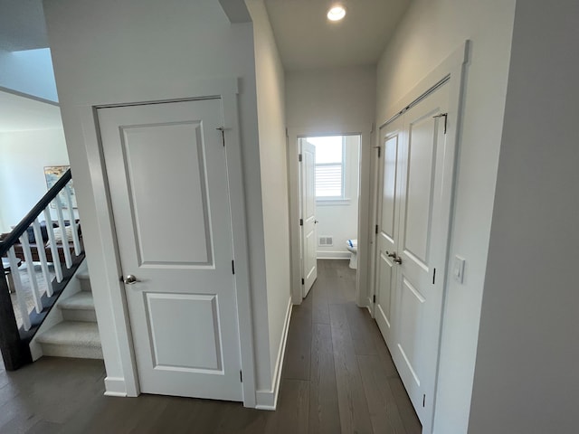 hallway with recessed lighting, baseboards, and dark wood-type flooring