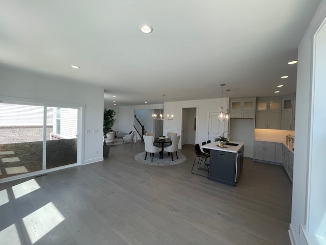living room featuring recessed lighting, wood finished floors, and a notable chandelier