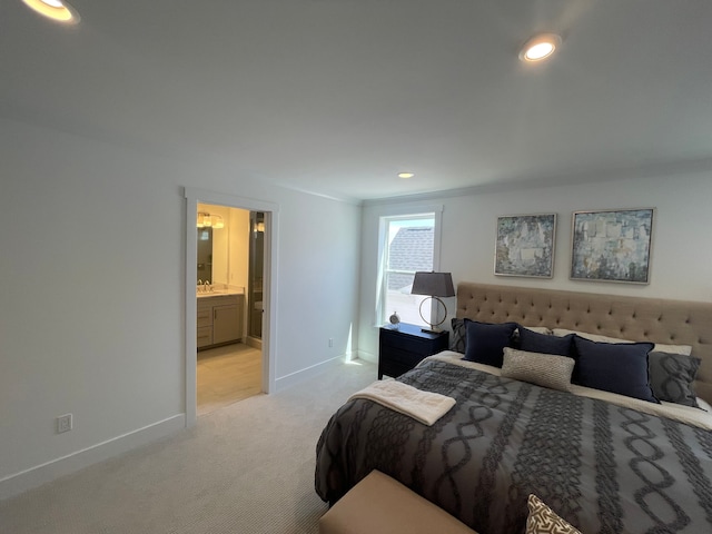 bedroom featuring baseboards, a sink, recessed lighting, and light carpet