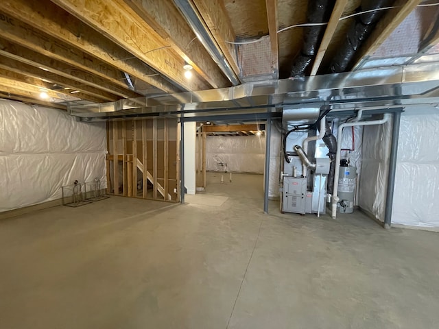 unfinished basement with heating unit and water heater
