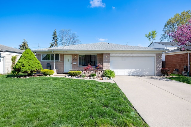 ranch-style home with a garage, brick siding, driveway, and a front yard