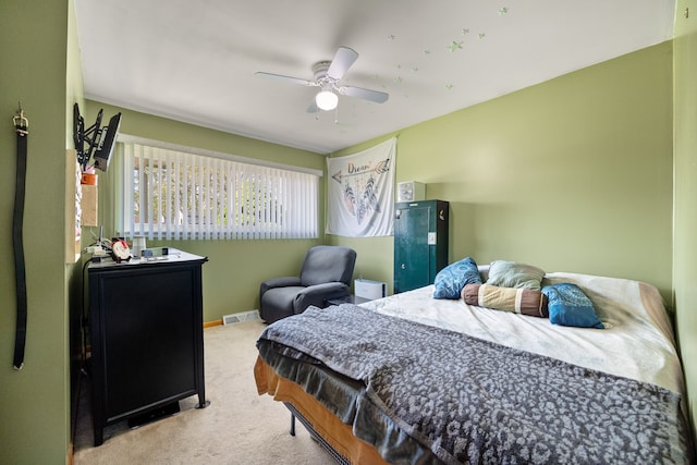 carpeted bedroom featuring ceiling fan and baseboards