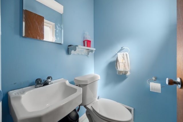 half bath featuring a sink and toilet