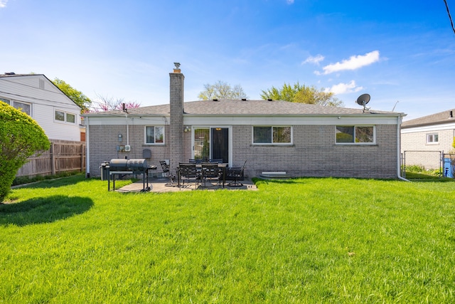 back of property with a chimney, a patio area, and brick siding