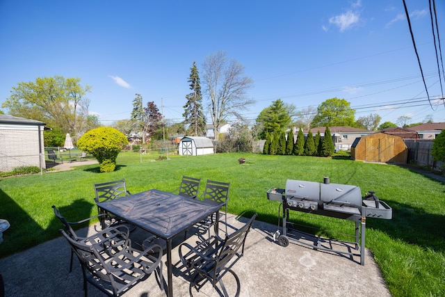 view of patio with a storage shed, outdoor dining area, and an outdoor structure