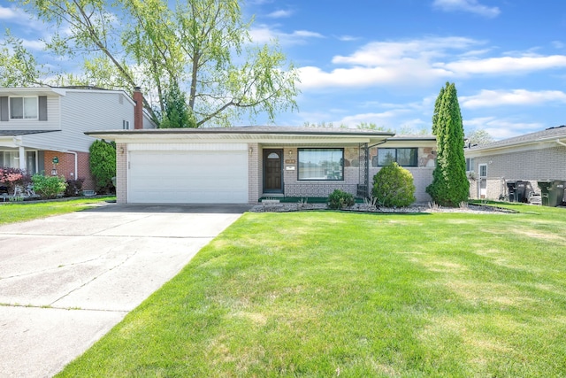 view of front of house with brick siding, a front lawn, an attached garage, and concrete driveway