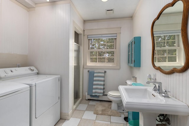 bathroom featuring crown molding, independent washer and dryer, toilet, and a shower stall