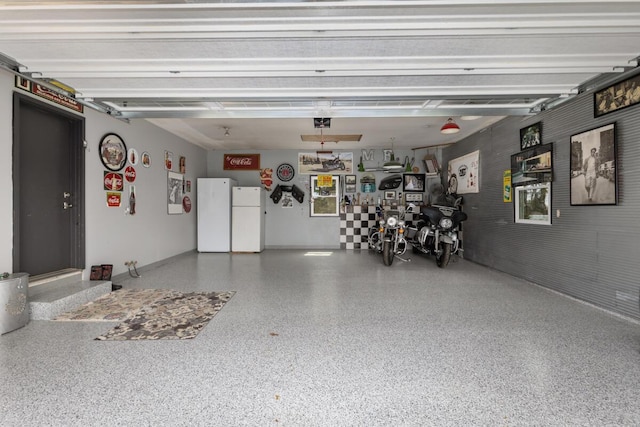garage with freestanding refrigerator and a garage door opener