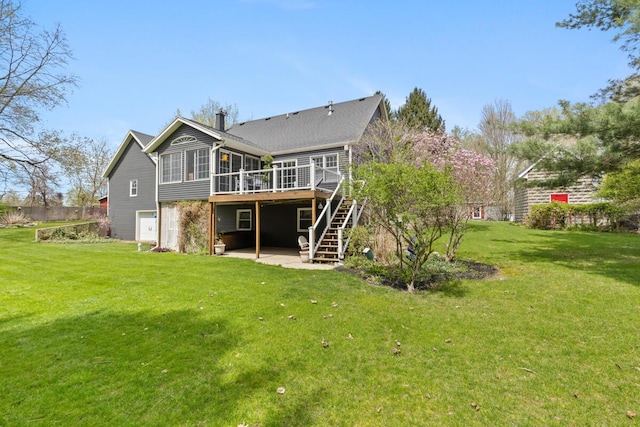 back of house featuring a deck, a chimney, a sunroom, stairs, and a yard