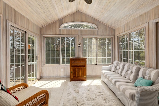 sunroom / solarium featuring wooden walls and lofted ceiling