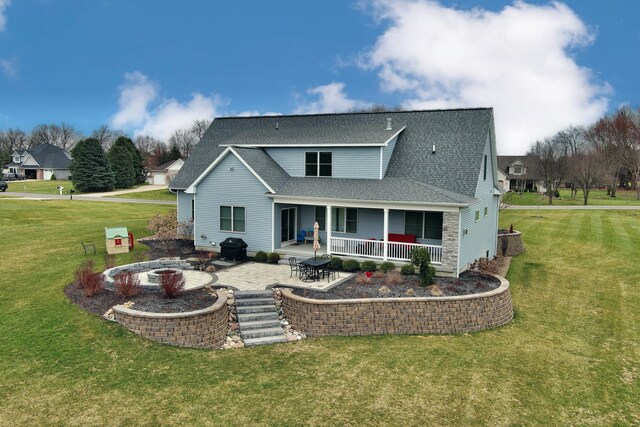 46140 Finch St, Mattawan, MI 49071 - back of house with a lawn, an outdoor fire pit, roof with shingles, and a patio area