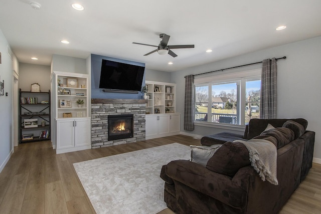 46140 Finch St, Mattawan, MI 49071 - living area with baseboards, a ceiling fan, wood finished floors, and a stone fireplace