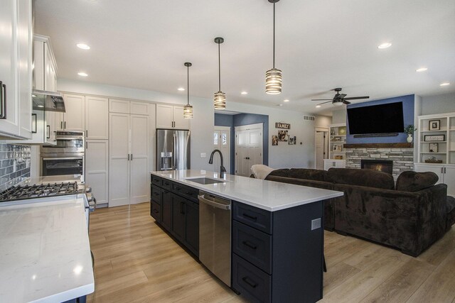 46140 Finch St, Mattawan, MI 49071 - kitchen with white cabinets, ceiling fan, appliances with stainless steel finishes, a sink, and light wood-type flooring