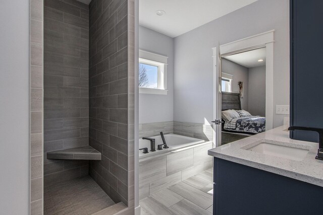 46140 Finch St, Mattawan, MI 49071 - ensuite bathroom featuring a garden tub, tile patterned flooring, a tile shower, vanity, and ensuite bath