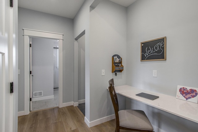 46140 Finch St, Mattawan, MI 49071 - home office with built in desk, baseboards, visible vents, and wood finished floors
