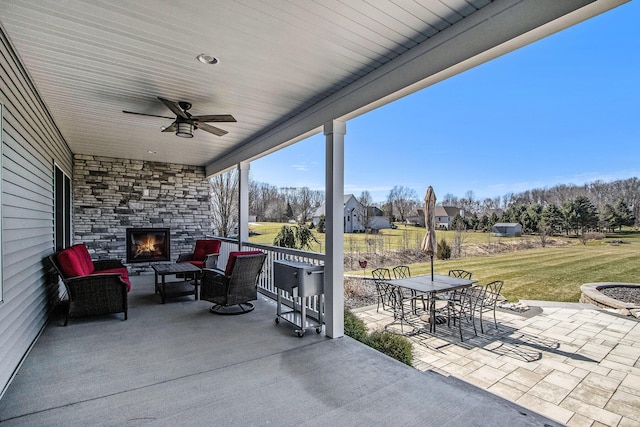 46140 Finch St, Mattawan, MI 49071 - view of patio featuring outdoor dining area, an outdoor living space with a fireplace, and ceiling fan