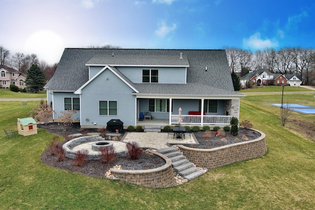 46140 Finch St, Mattawan, MI 49071 - back of house with roof with shingles, a yard, a patio area, and an outdoor fire pit