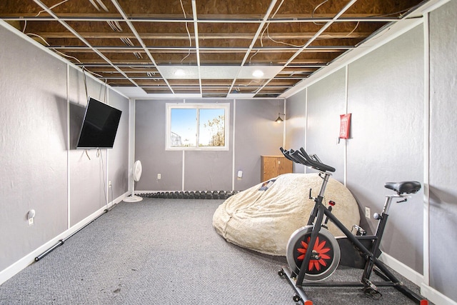 exercise area featuring baseboards and carpet flooring