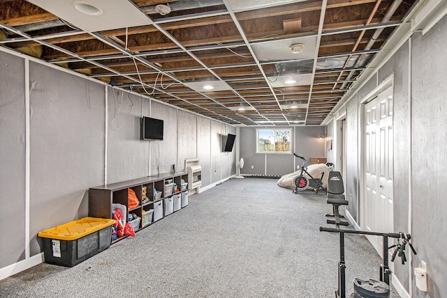 below grade area featuring carpet floors and baseboards