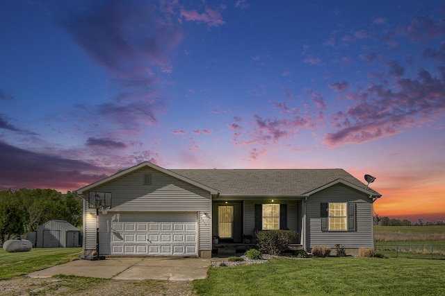 single story home featuring covered porch, an attached garage, driveway, and a front lawn
